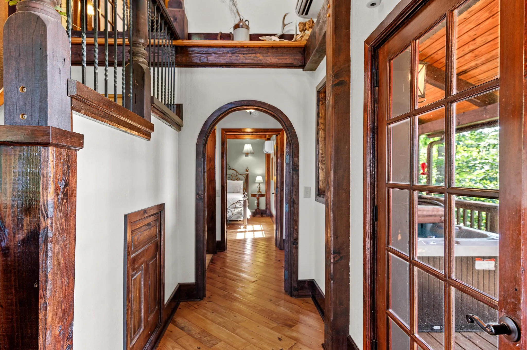 Arched Hallway Interior hallway with distinctive arched wooden doorway and hardwood flooring