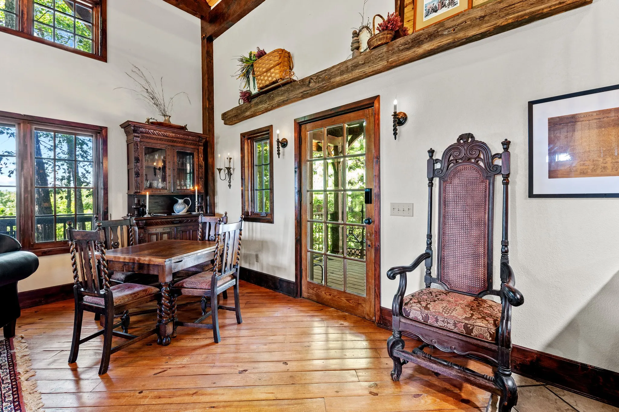 Dining Room Formal dining area with antique wooden furniture, ornate chair, and tall timber beams