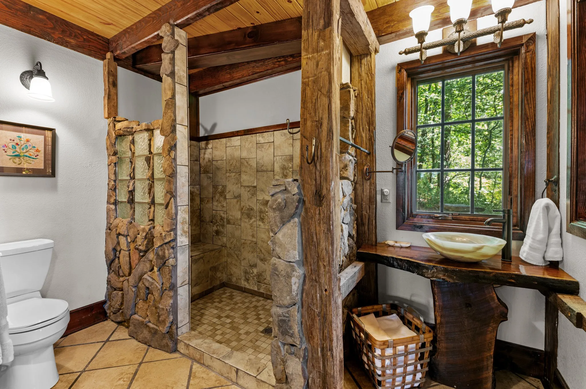 Downstairs Bathroom Luxurious bathroom with custom walk-in shower, wooden accents, and large window with forest view