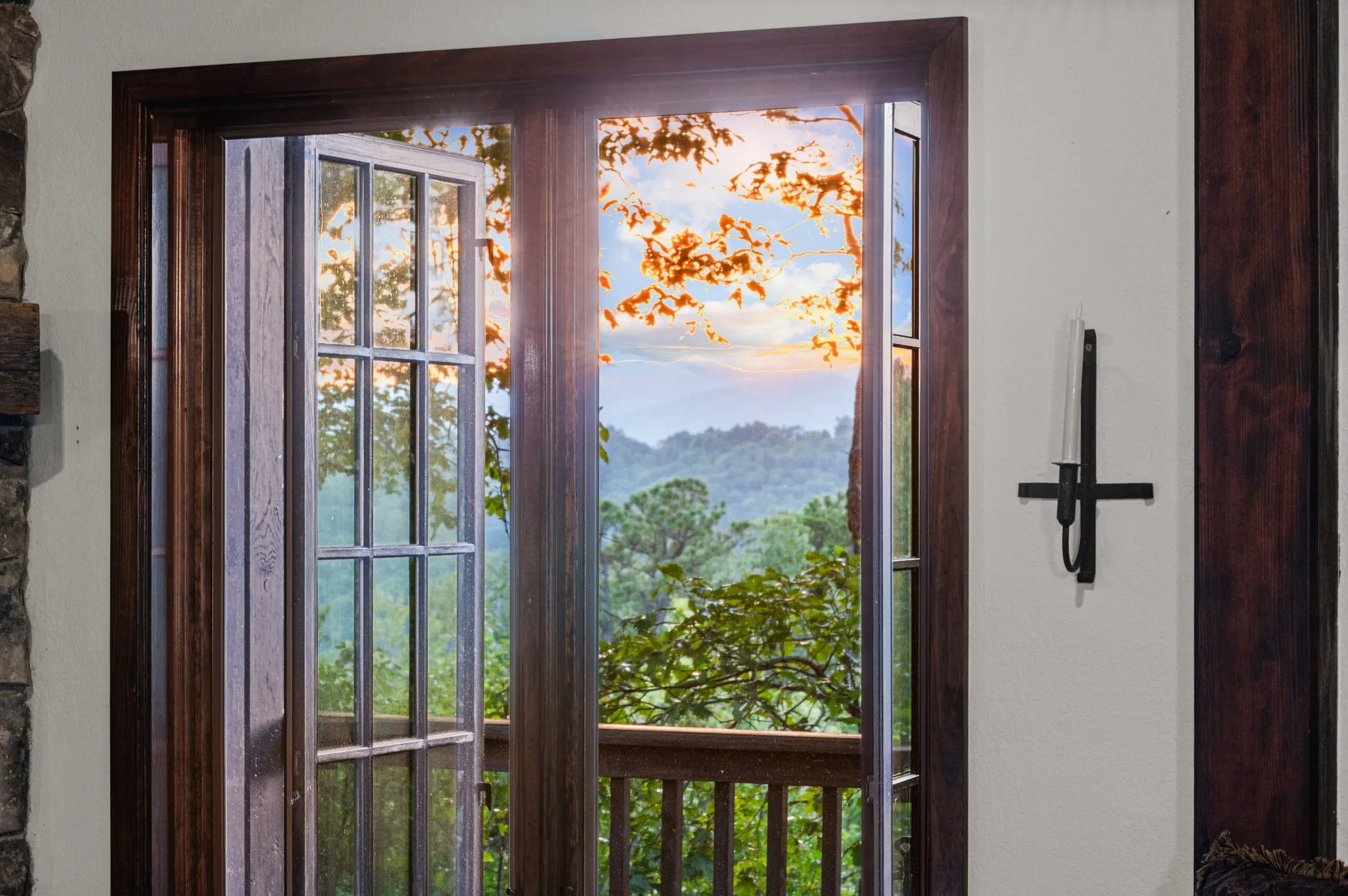 Mountain View Doors Glass doors with rustic wood frame opening onto deck overlooking mountain landscape with autumn foliage